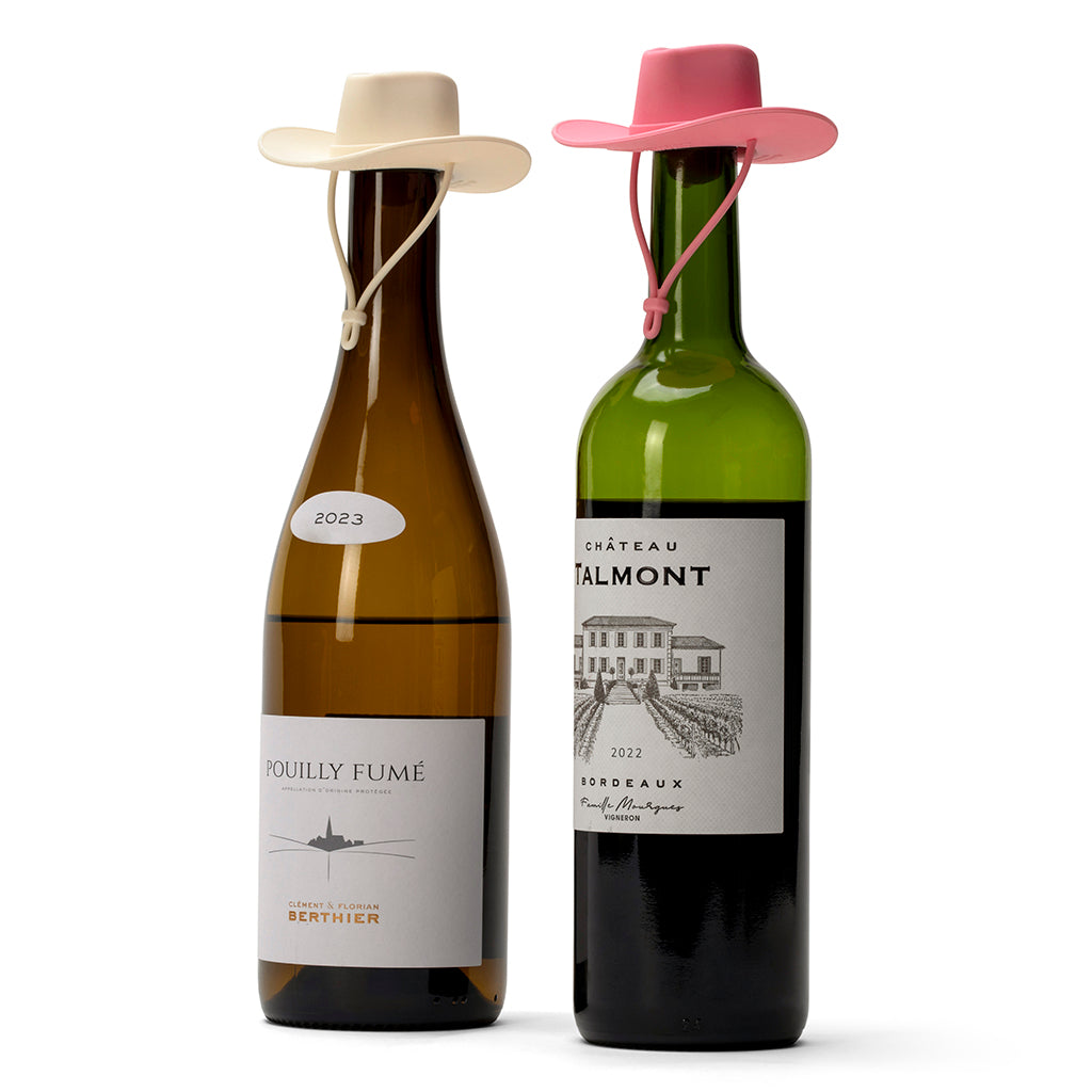 Set of two cowgirl hat silicone wine bottle stoppers for sealing opened wine bottles.