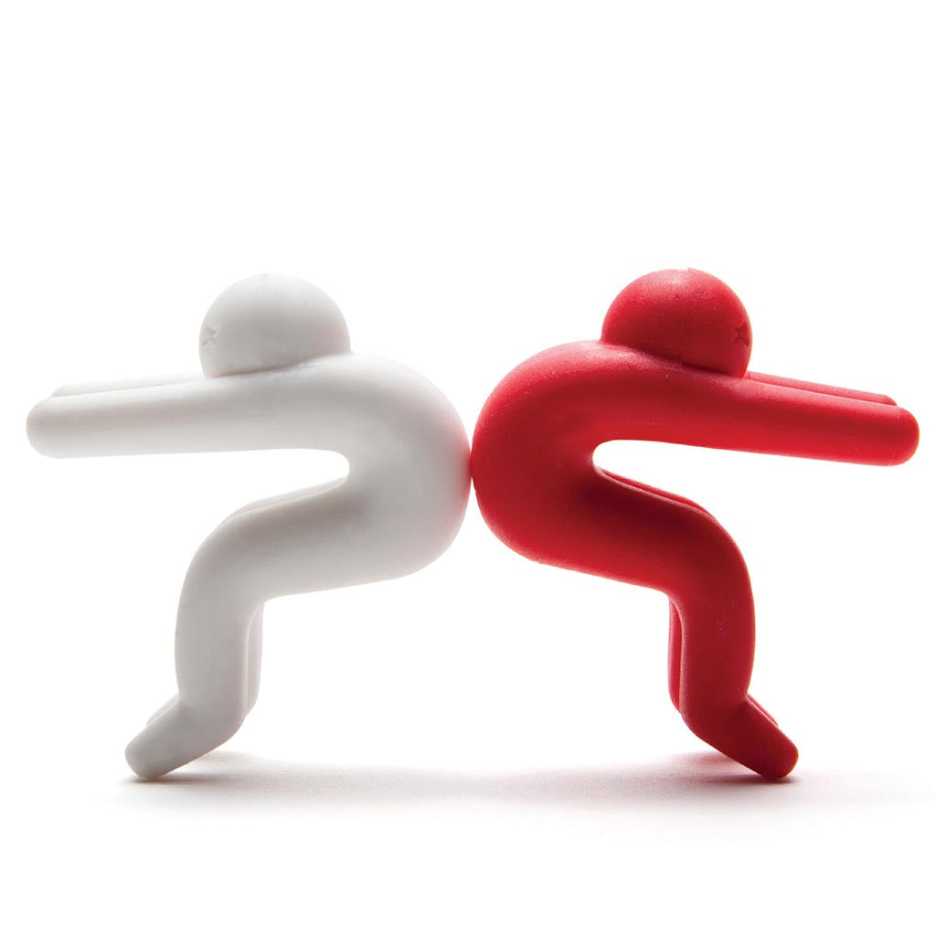 Cute silicone figurine propping up a pot lid