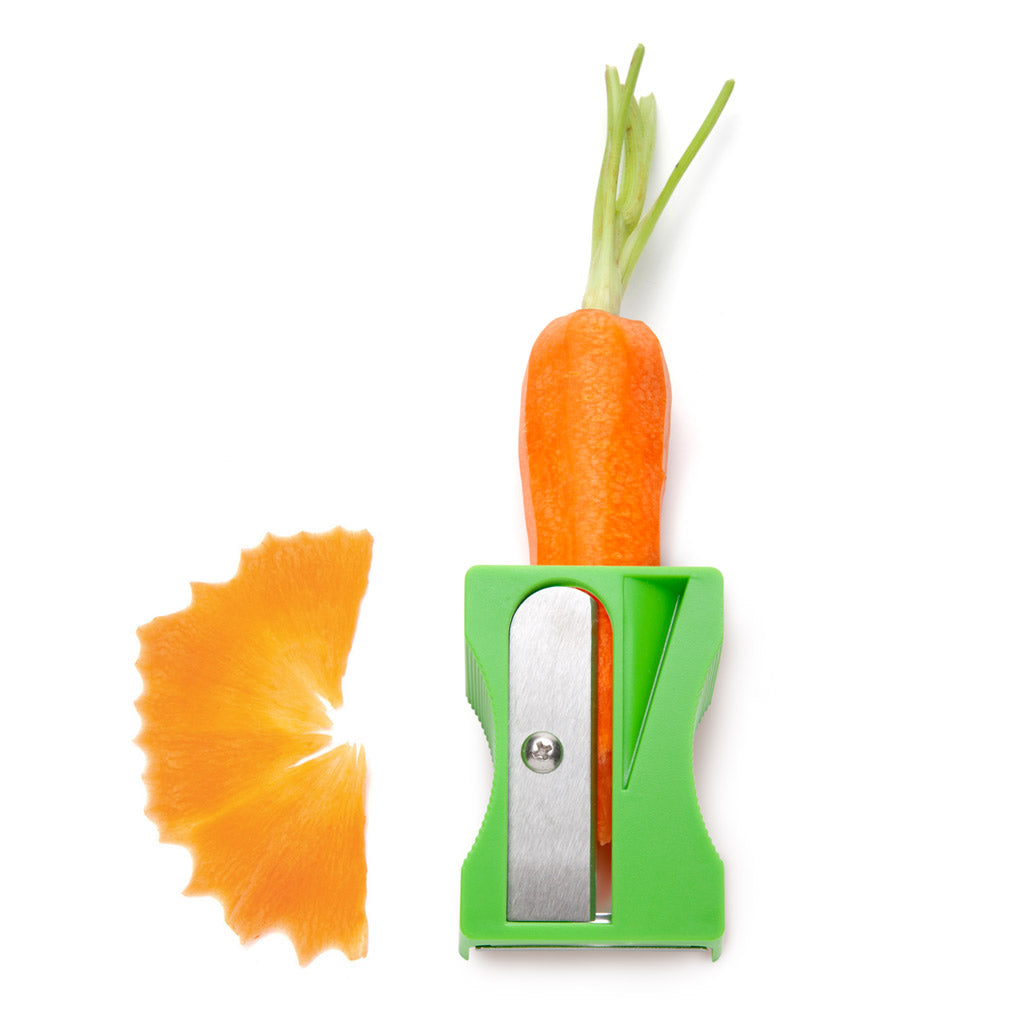 Green Pencil-style veggie peeler shaping vegetables into ribbons